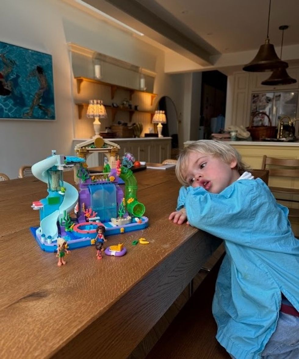 Louise Thompson's son Leo with the Heartlake City Water Park toy from the Lego Group
