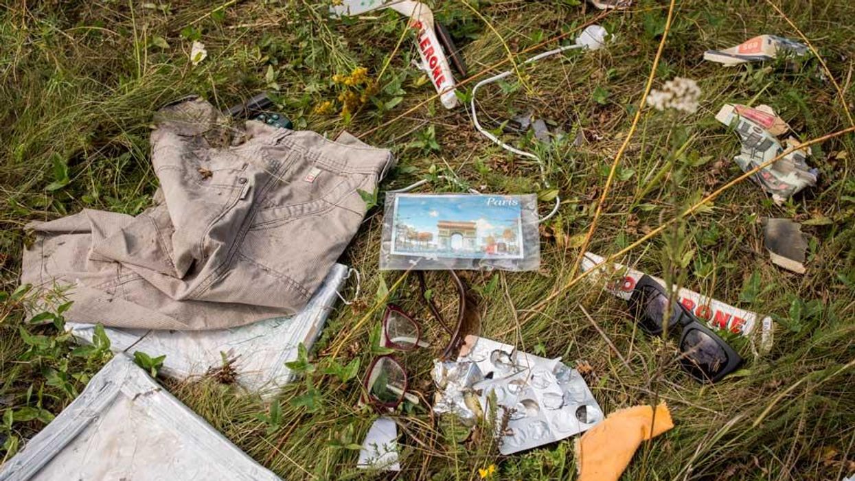 Luggage and personal possessions from MH17 victims at the site of the crash