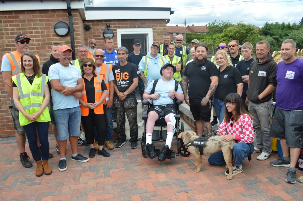 Luke Goold-Hannatt with some of the team who helped with the extension. (Band of Builders/ PA)