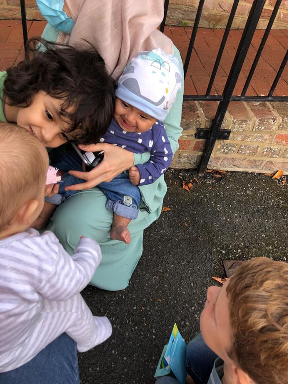 Madiha (wearing a hat), with her brother, Wais, 2, looking at Barney. Archer, 6, Barney\u2019s brother is on the far right of the photo (Matt Simmons/PA).