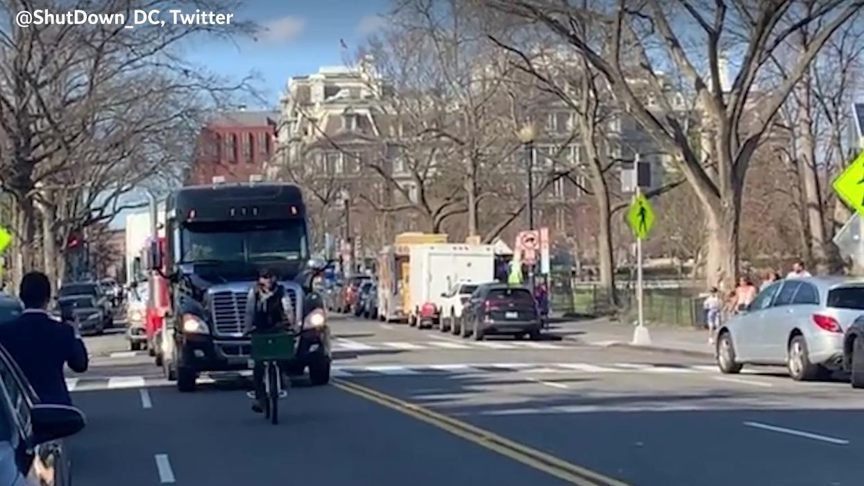Angry MAGA truck convoy halted by one guy on a bike