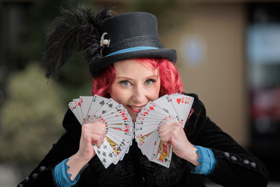 Magician Nikola Arkane holding cards
