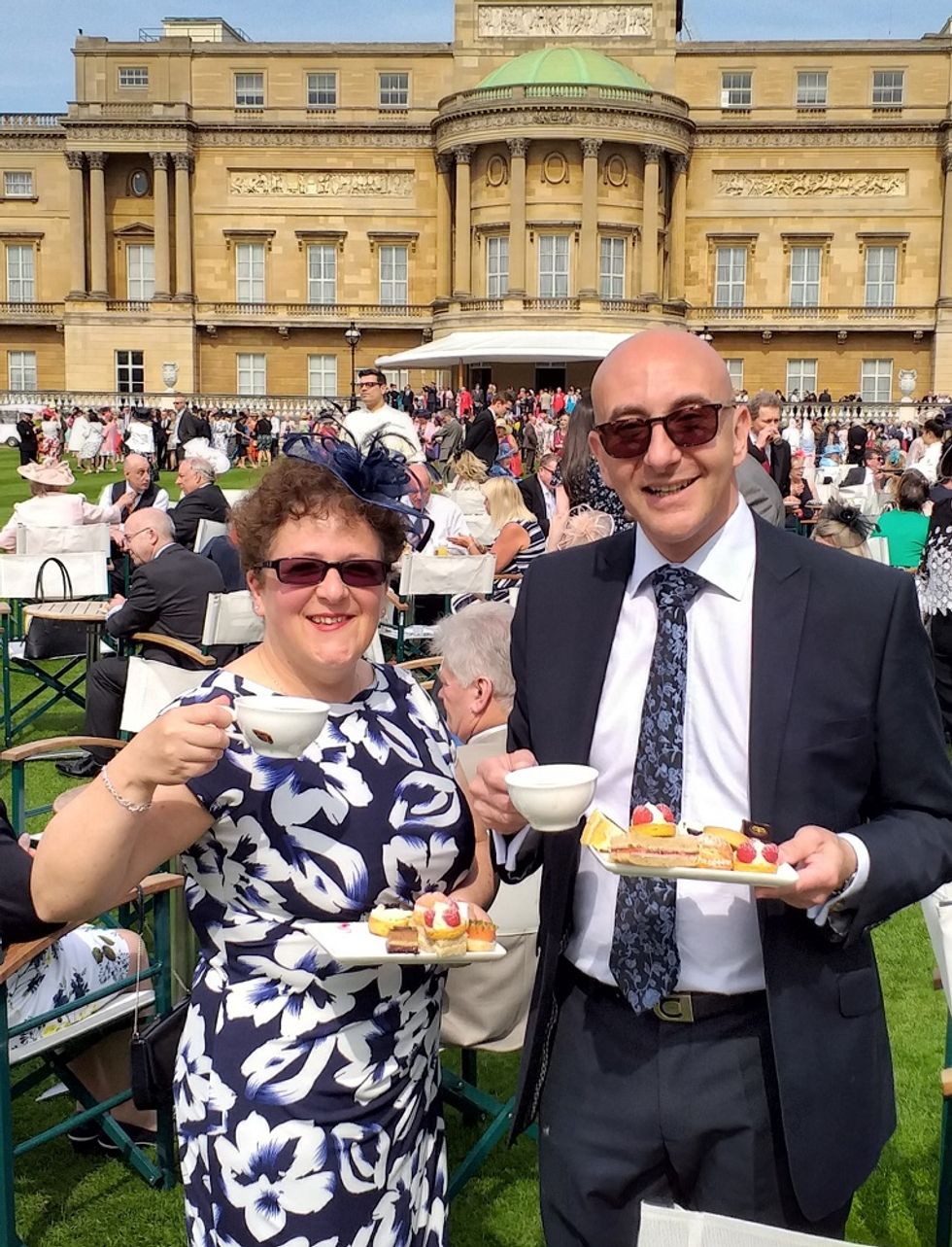 Man and woman with plates and cups in their hands