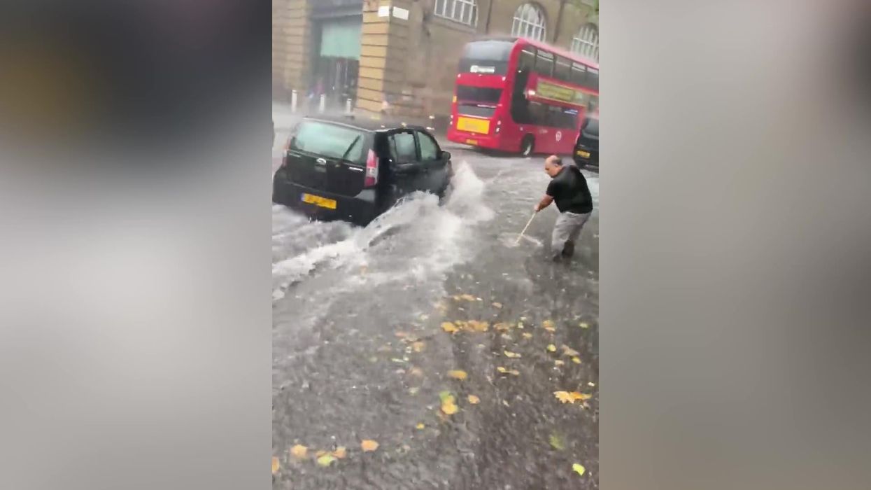 Man attempts to get rid of 'ocean' flood in London - using a sweeping brush