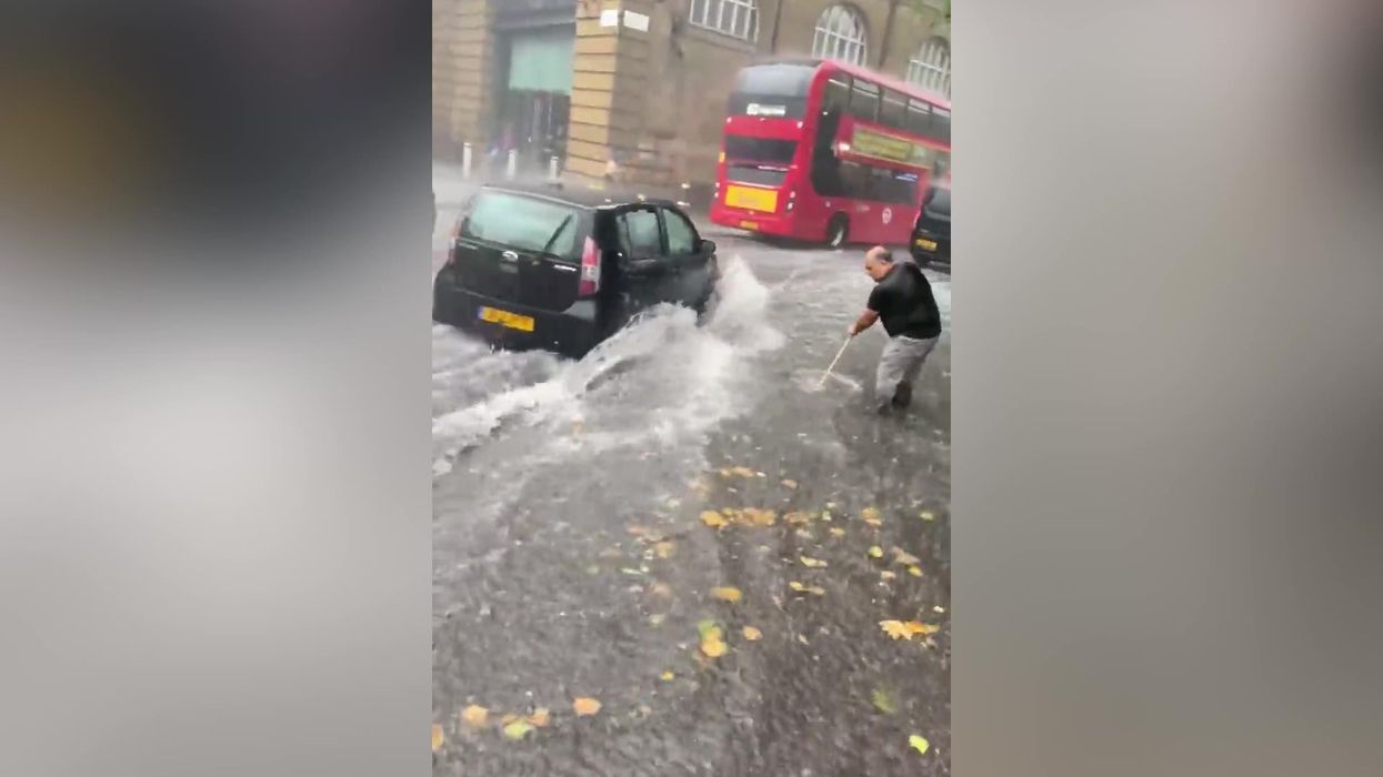 Man attempts to get rid of 'ocean' flood in London - using a sweeping brush