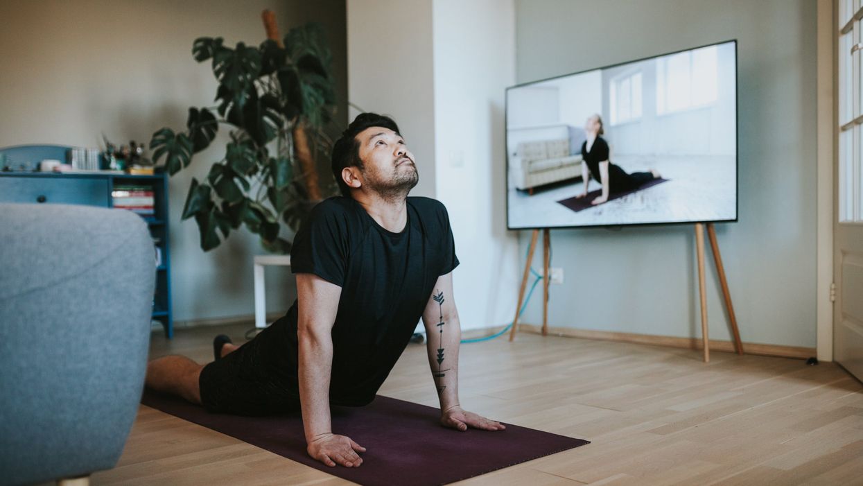 <p>Man does exercise in his living room</p>