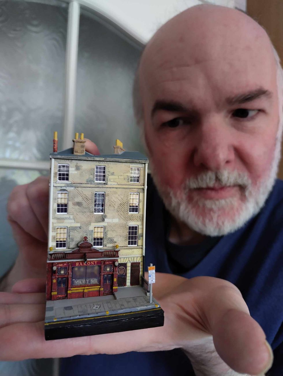 Man holding mini pub
