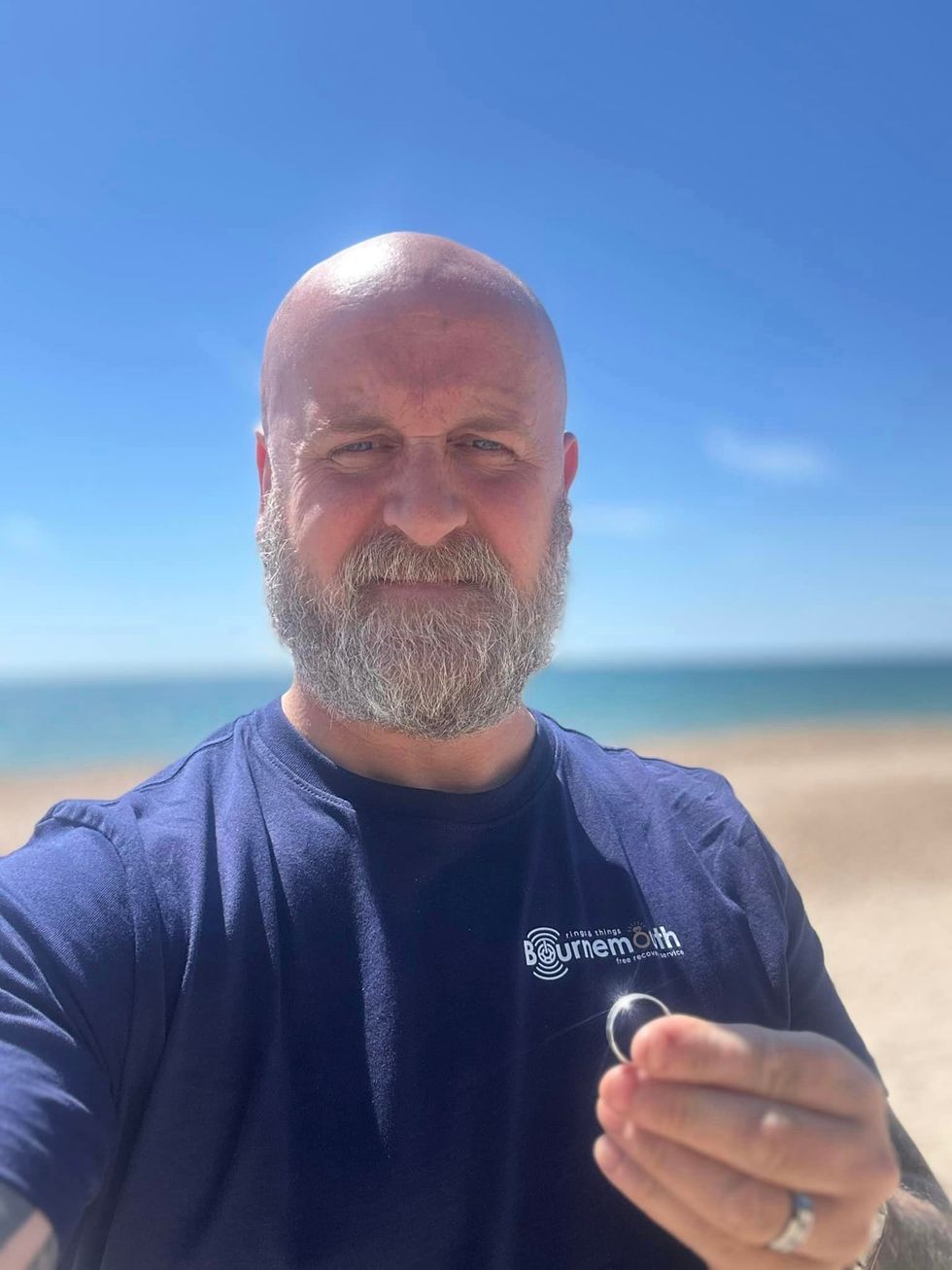 Man holding ring in hand