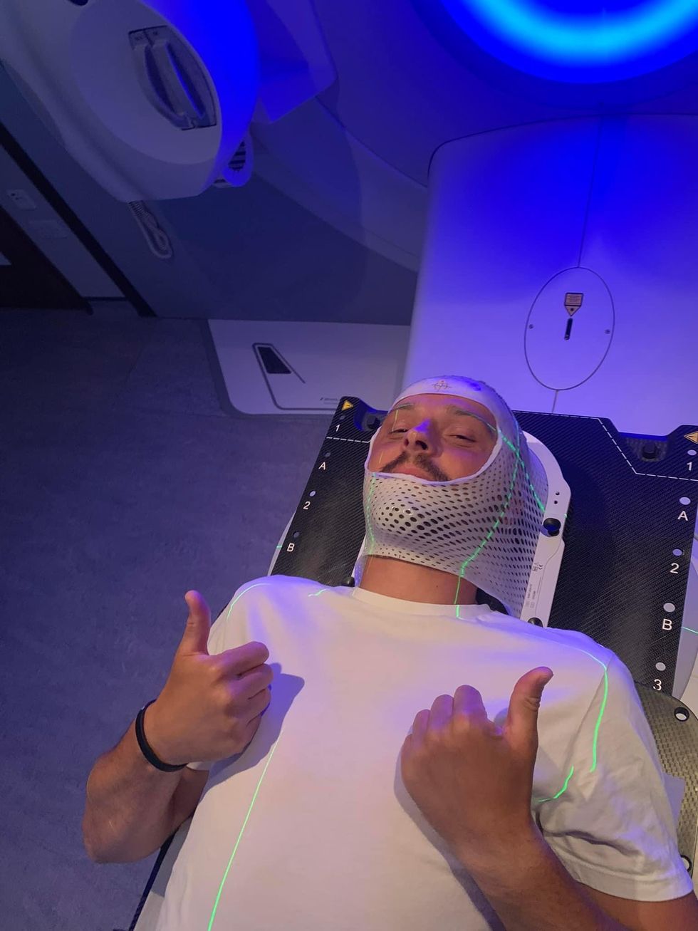 Man lying down with thumbs up