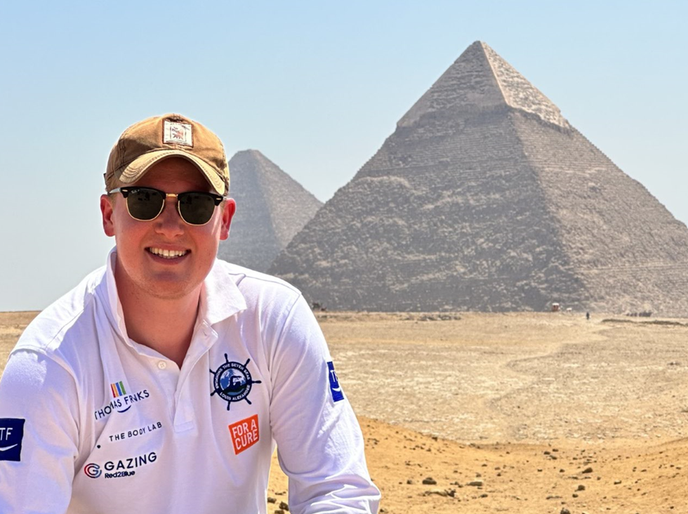Man posing in front of pyramids
