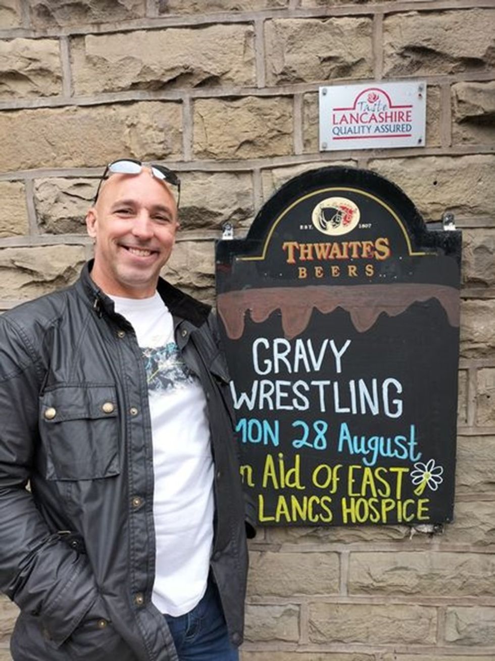 Man posing next to sign