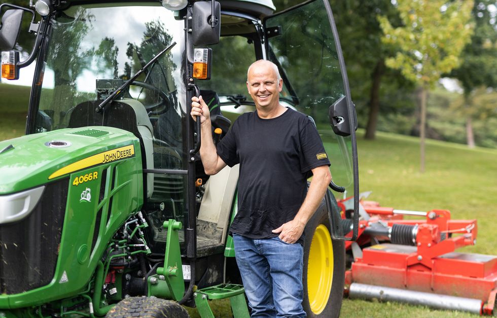 Man posing with tractor
