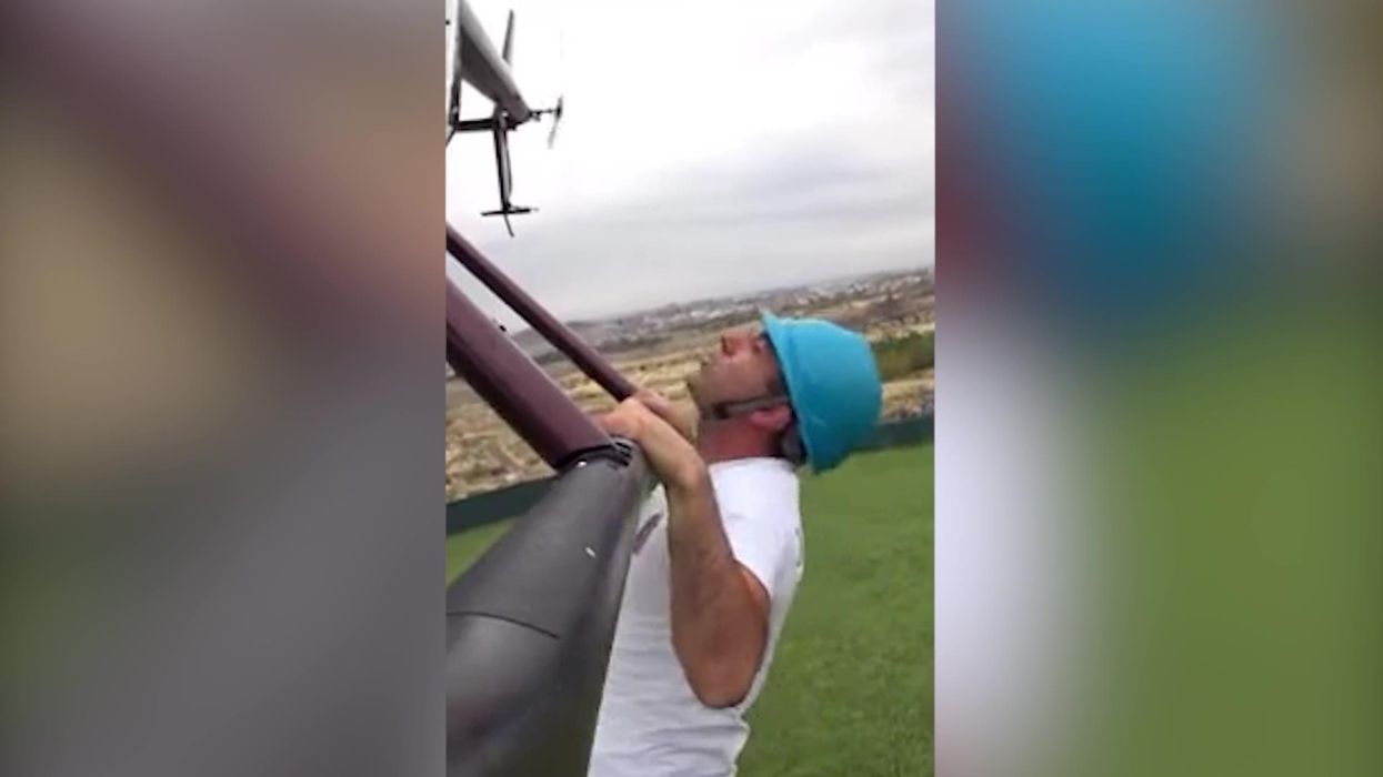 Man creates Guinness World Record for most pull-ups while hanging down from helicopter