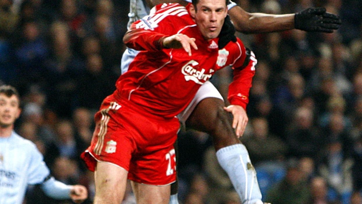 Manchester City‘s Micah Richards and Liverpool’s Jamie Carragher battle for the ball