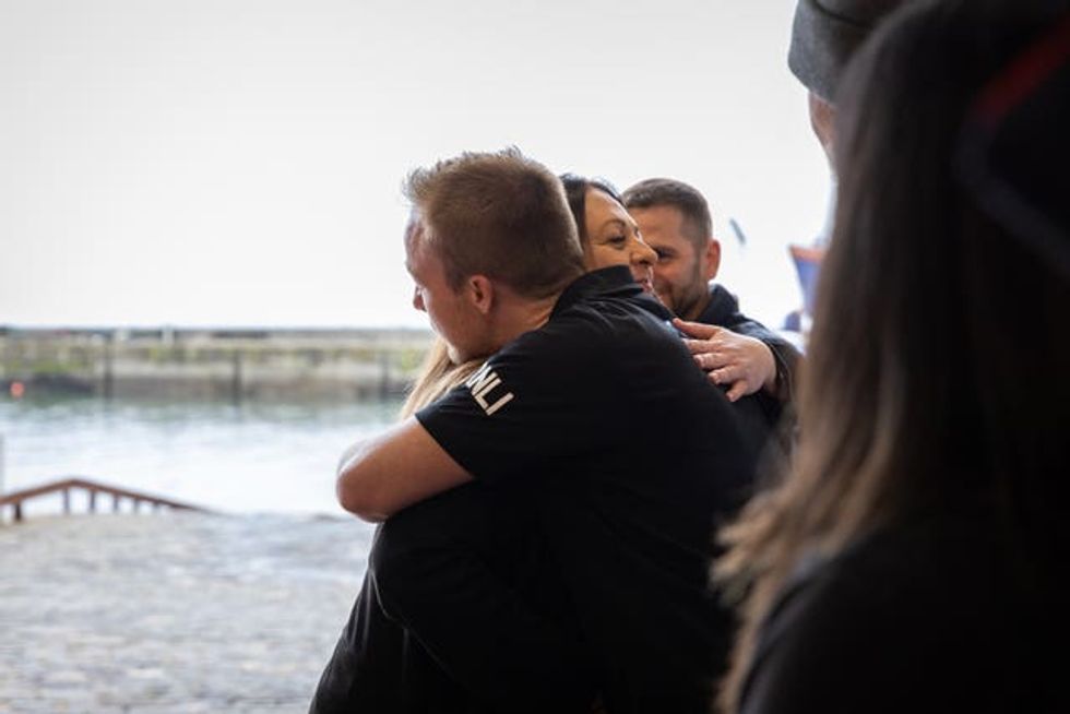 Mandy Galloway hugging a member of the Anstruther RNLI lifeboat volunteers