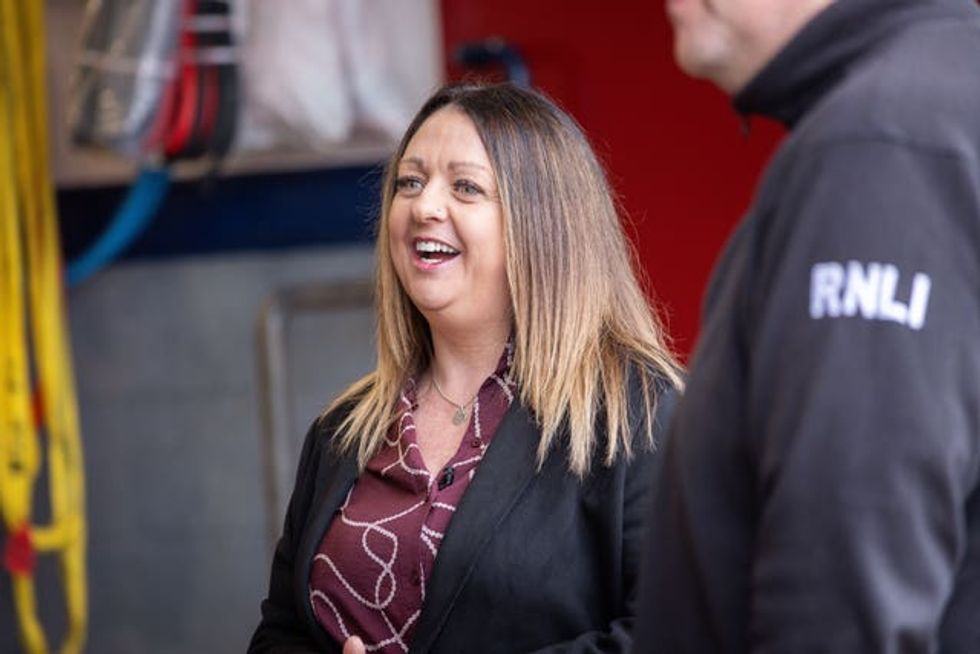 Mandy Galloway laughing during a meeting with members of the Anstruther RNLI lifeboat volunteers who helped rescue her
