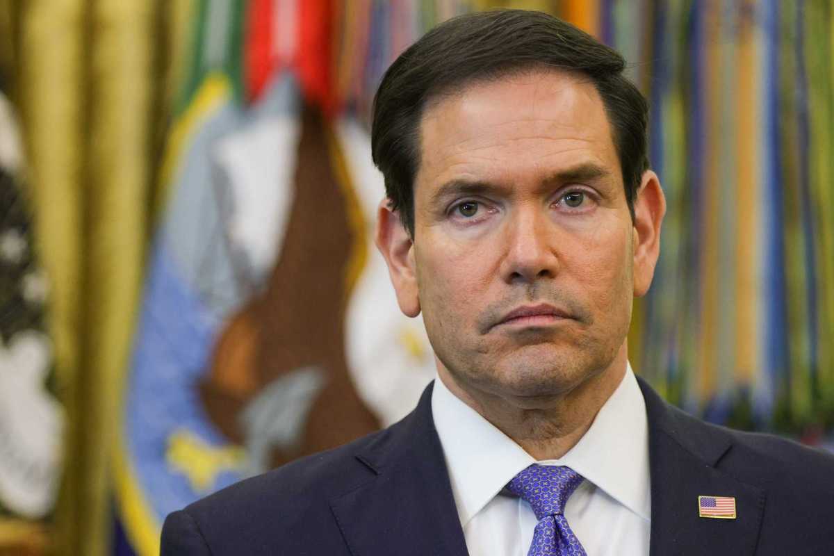 Marco Rubio, a white man with short black hair and neutral facial expression, in the Oval Office.
