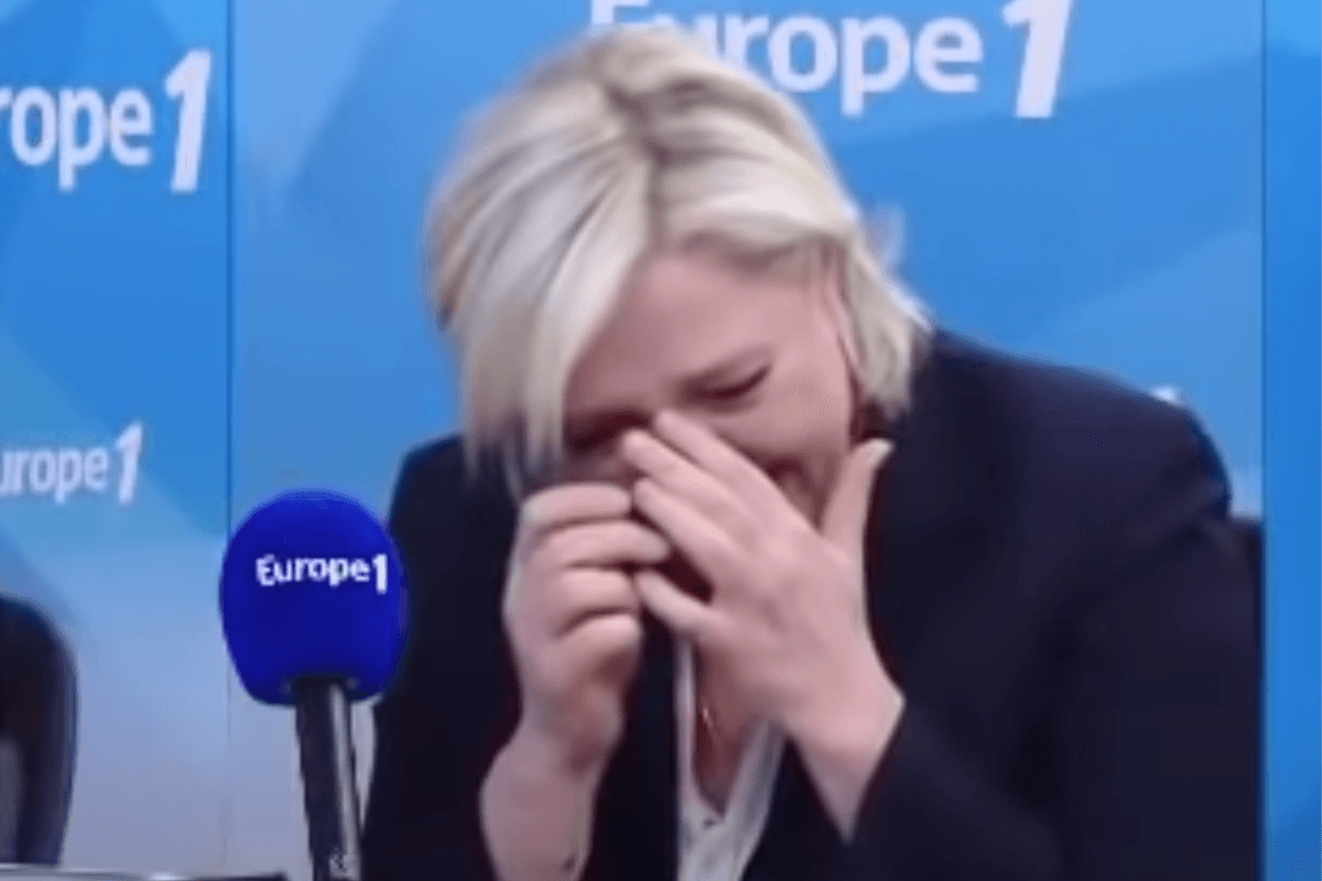 Marine Le Pen wipes her eyes as she cries with laughter while appearing on the Europe 1 radio station.