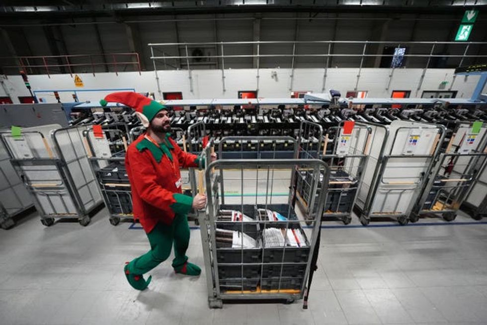 Mark Dawson pushes a mail trolley while dressed as an elf