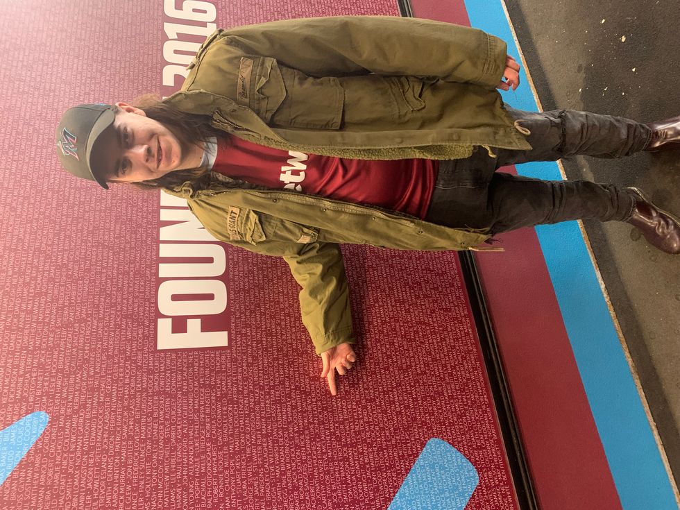 Mark's son, Jack Sullivan, pointing to his own name on the Founder's Poster at West Ham's London Stadium