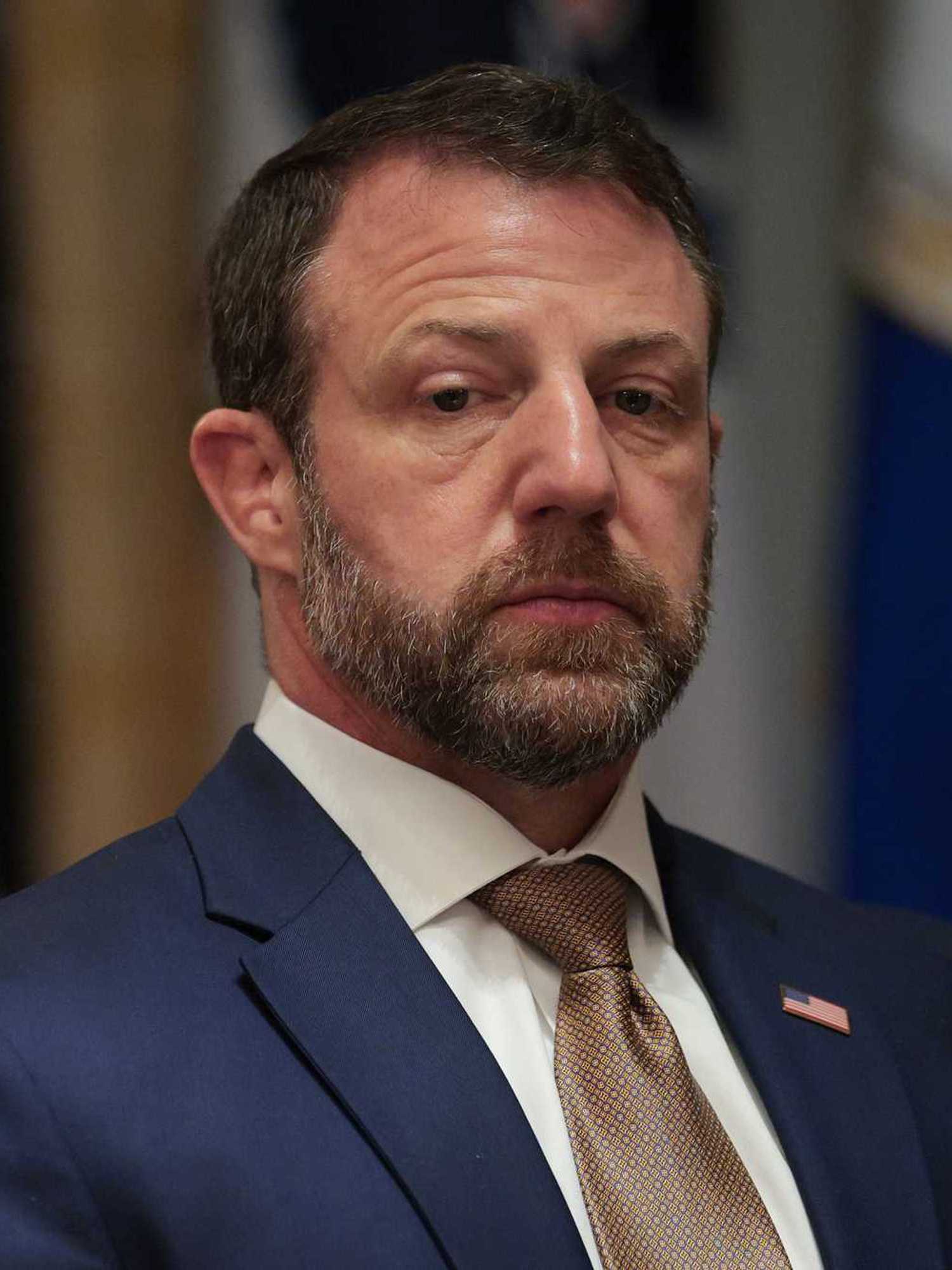 Markwayne Mullins, a bearded white man with short black hair and a blue suit.