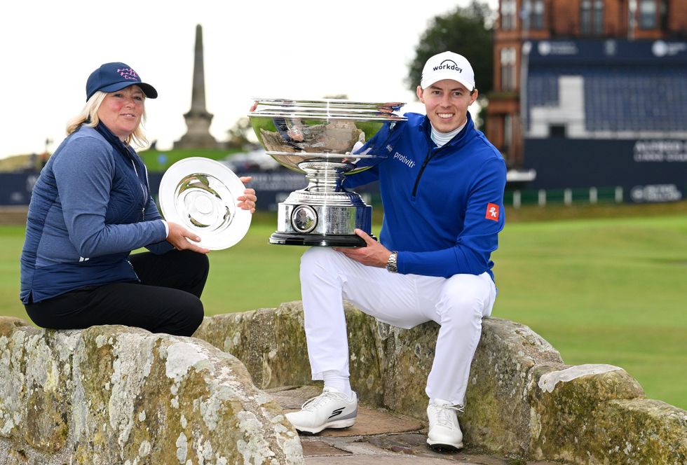 Matt Fitzpatrick of England poses with the trophy on the Swilcan Bridge alongside his Mother and playing partner, Susan Fitzpatrick following his victory and their team victory Day Five of the Alfred Dunhill Links Championship