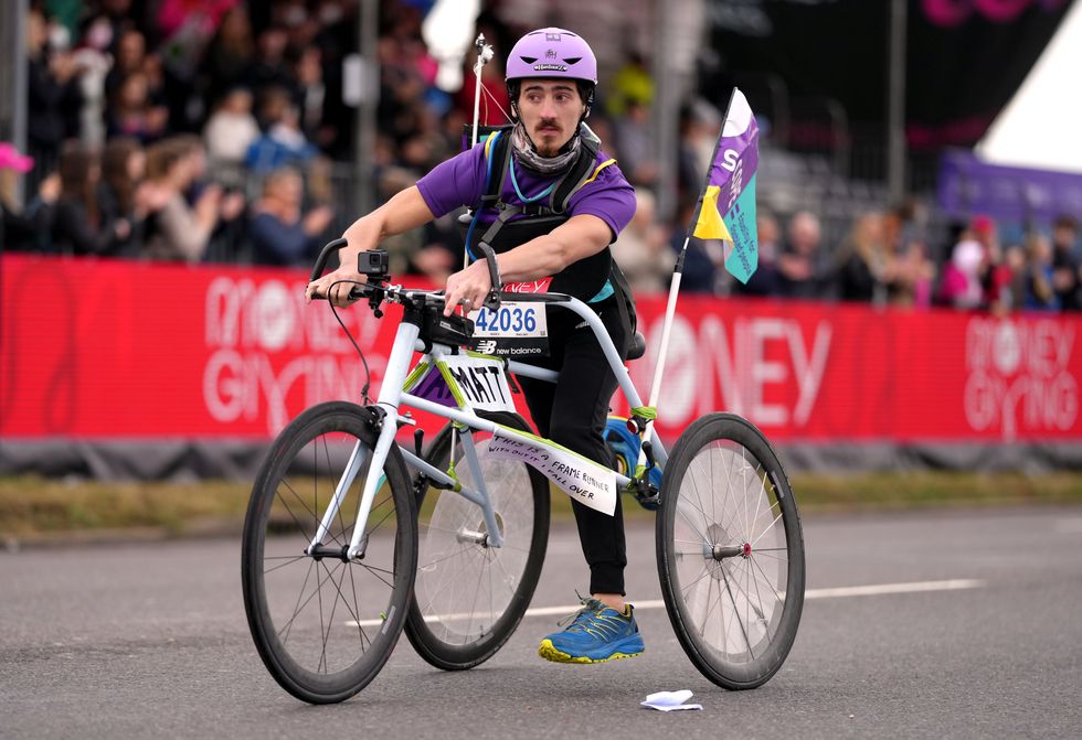 Matt Humphreys using a frame runner to run for Scope Charity (John Walton/PA)