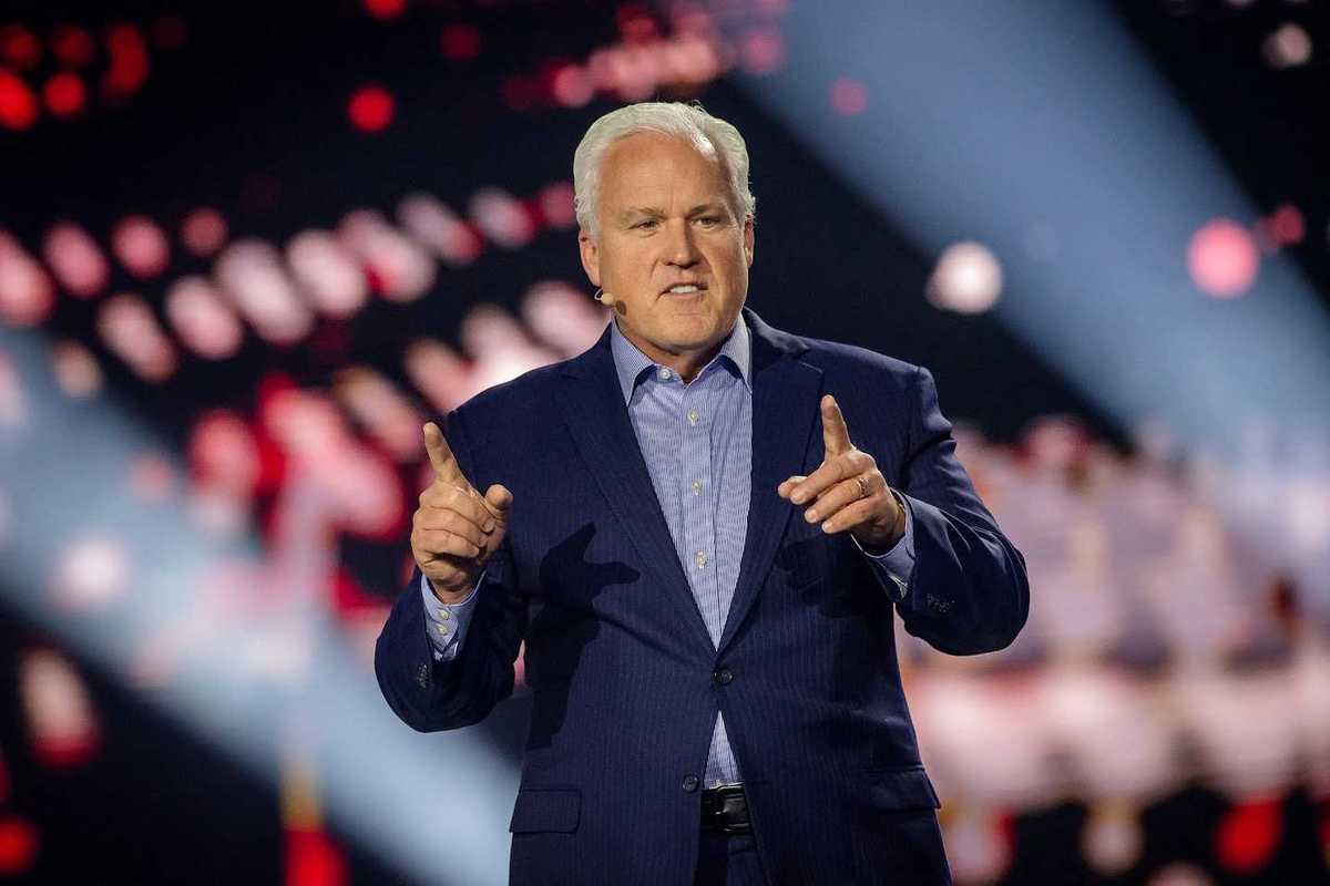 Matt Schlapp, a white man with short white hair and a blue suit, speaking onstage.