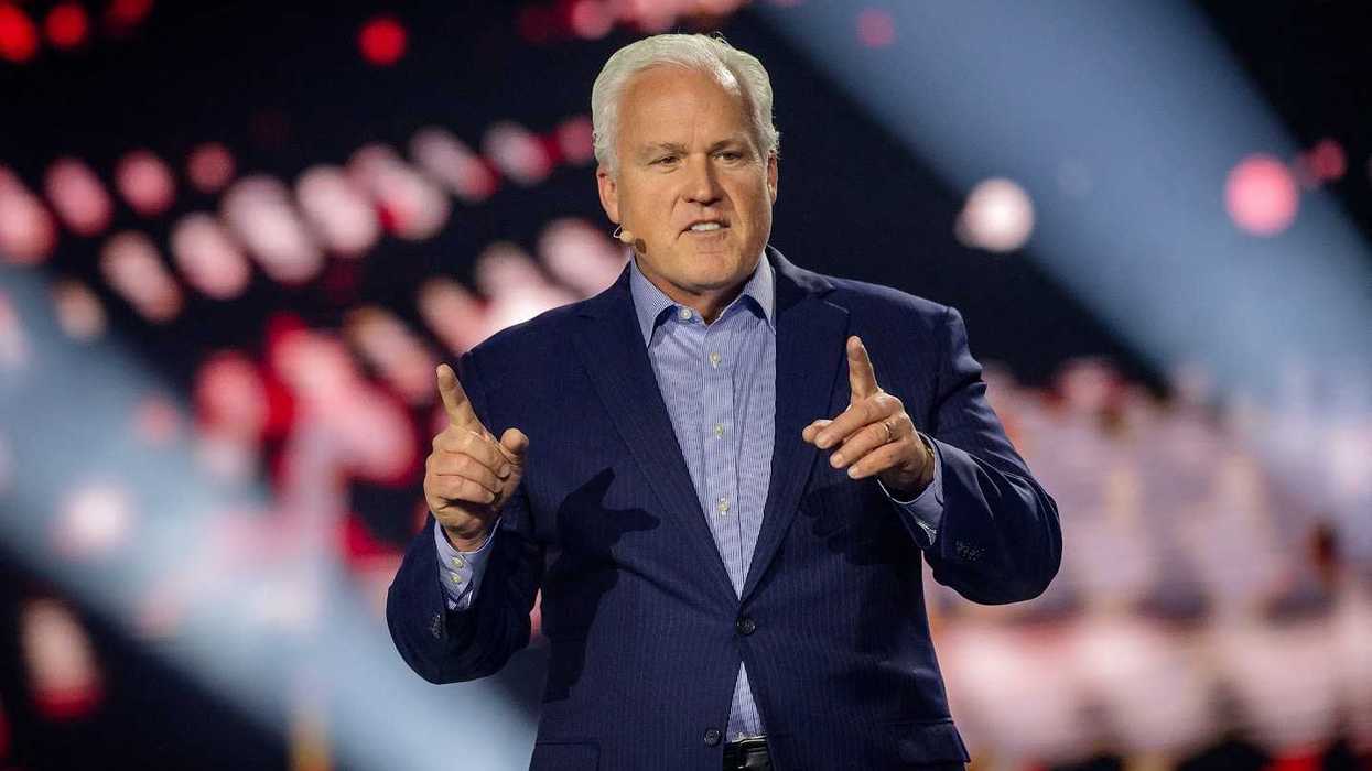 Matt Schlapp, a white man with short white hair and a blue suit, speaking onstage.