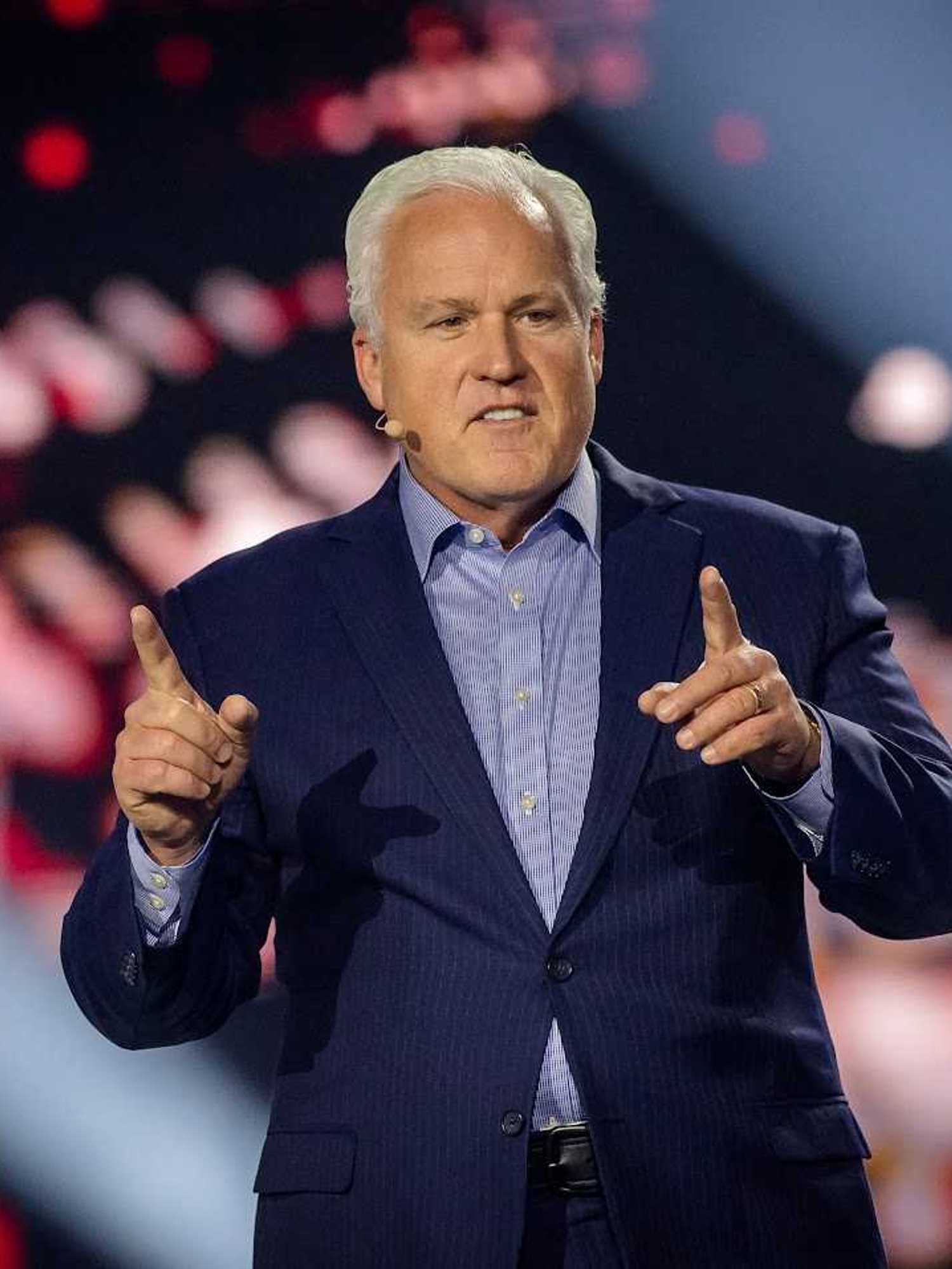 Matt Schlapp, a white man with short white hair and a blue suit, speaking onstage.