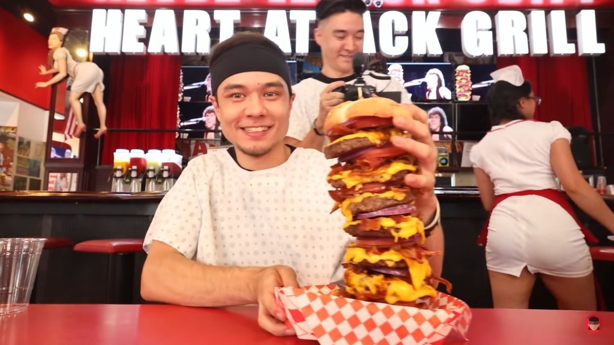 <p>Matt Stonie with the giant burger</p>
