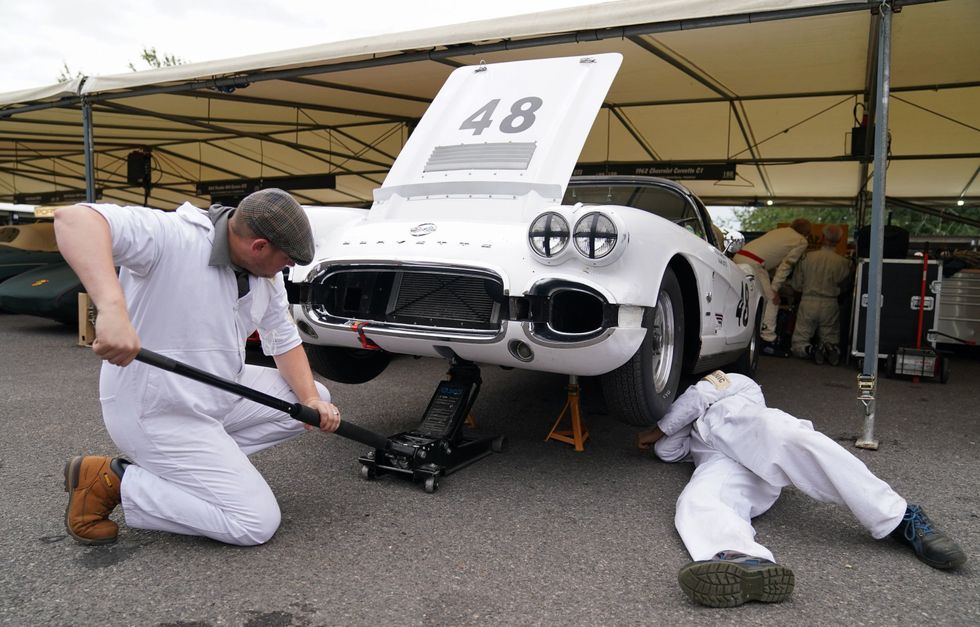 Mechanics work on a 1962 Chevrolet Corvette C1 (Andrew Matthews/PA)
