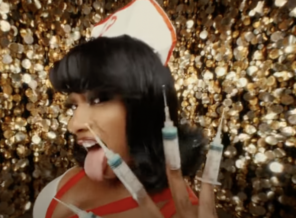 Megan Thee Stallion shows off booster shot nails