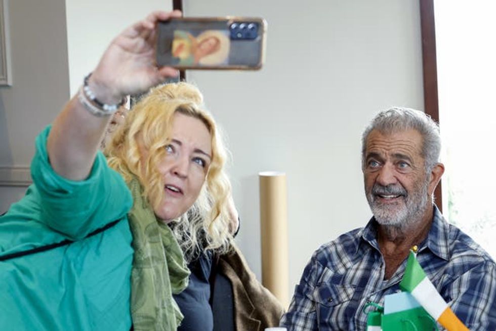 Mel Gibson poses for a selfie