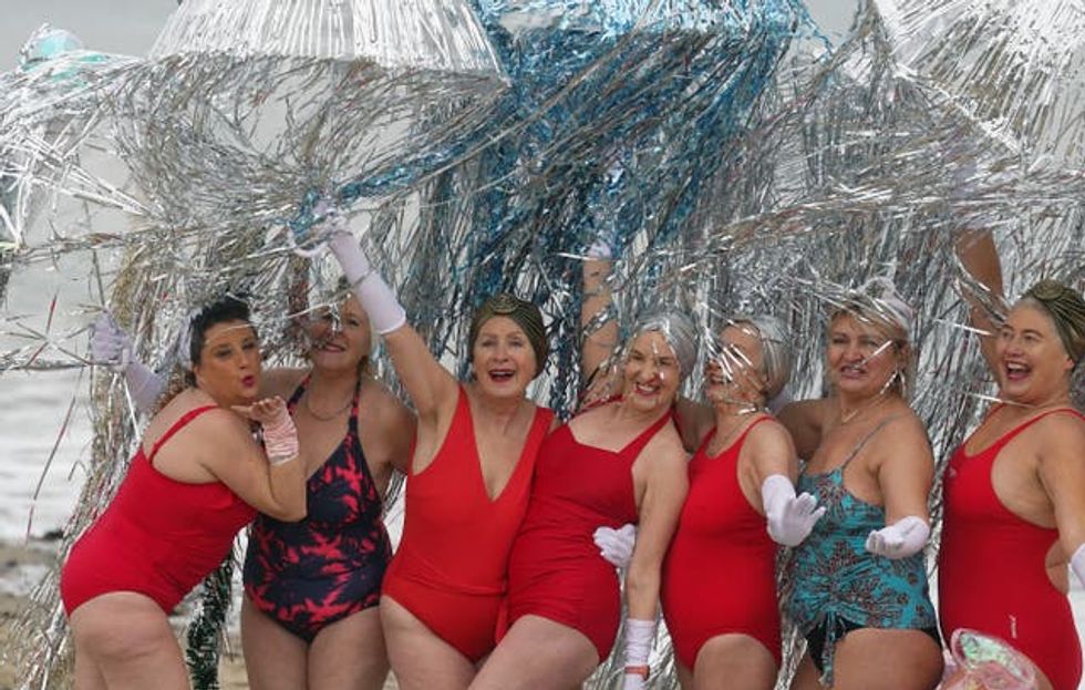 Members of the Bray Beach Bathers arrive to take part in the annual New Year\u2019s day charity swim on Bray seafront in County Wicklow