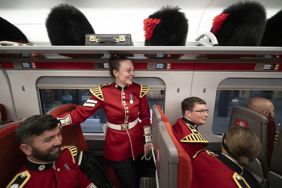 In Pictures: Bearskin caps in the luggage rack as Coldstream Guards return home
