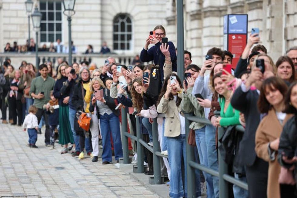 Members of the public await the arrival of the King  (Chris Jackson/PA)