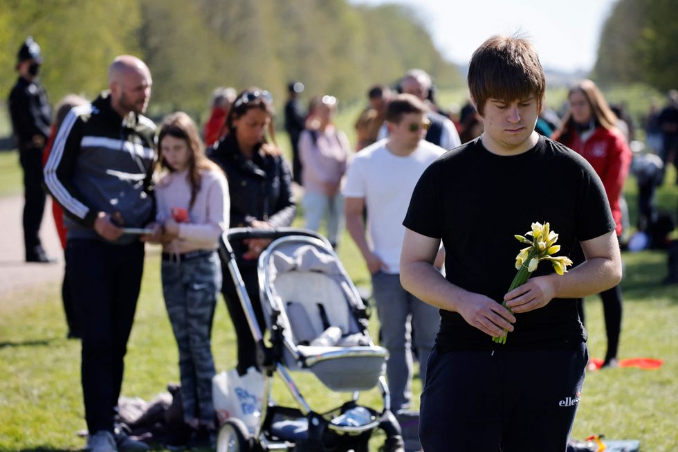 Members of the public observe a minute\u2019s silence on the Long Walk in Windsor