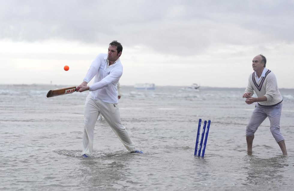In Pictures: Waterlogged pitch perfect for cricketers playing annual game in sea