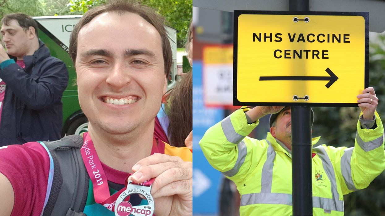 Mencap ambassador Harry Roche, who has a learning disability, and a Brent Council worker hangs a direction sign to the NHS Covid Vaccine Centre at the Olympic Office Centre, Wembley (Harry Roche and Yui Mok/PA)