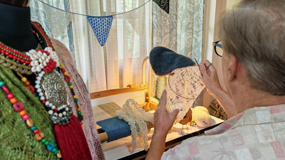 Michael Harrigan pictured from behind working on a piece of knitwear