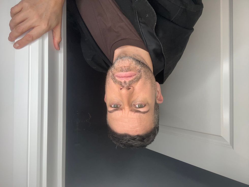 Michael Spicer peers out of a door