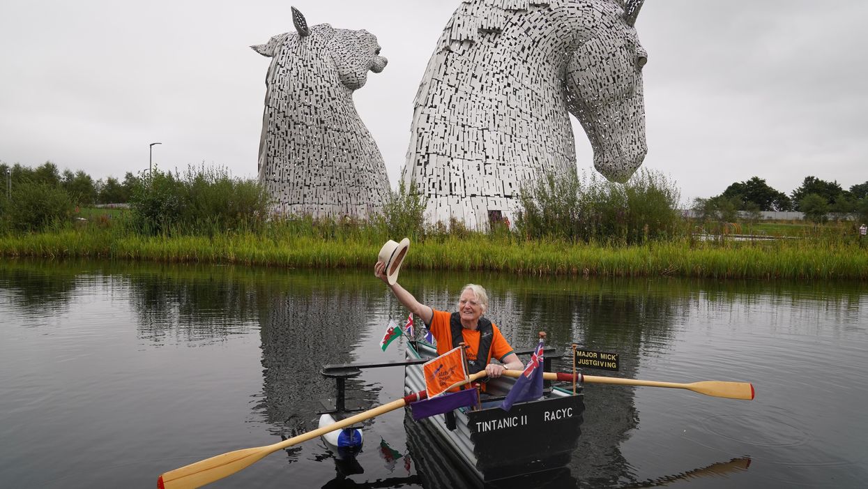 Michael Stanley rows his boat Tintanic II along the Forth and Clyde Canal past the Kelpies (Andrew Milligan/PA)