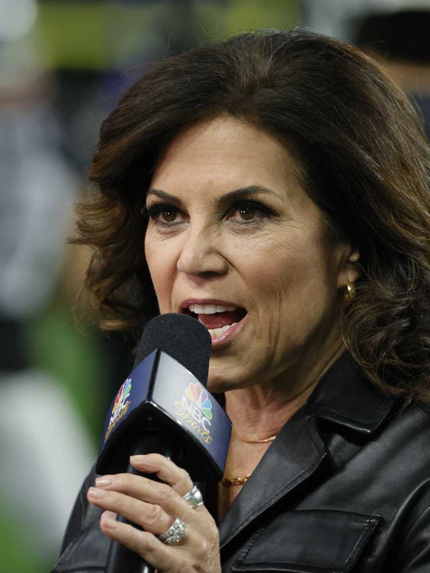 Michele Tafoya, a white woman with long brown hair and a black jacket, speaking into an MSNBC-branded microphone.