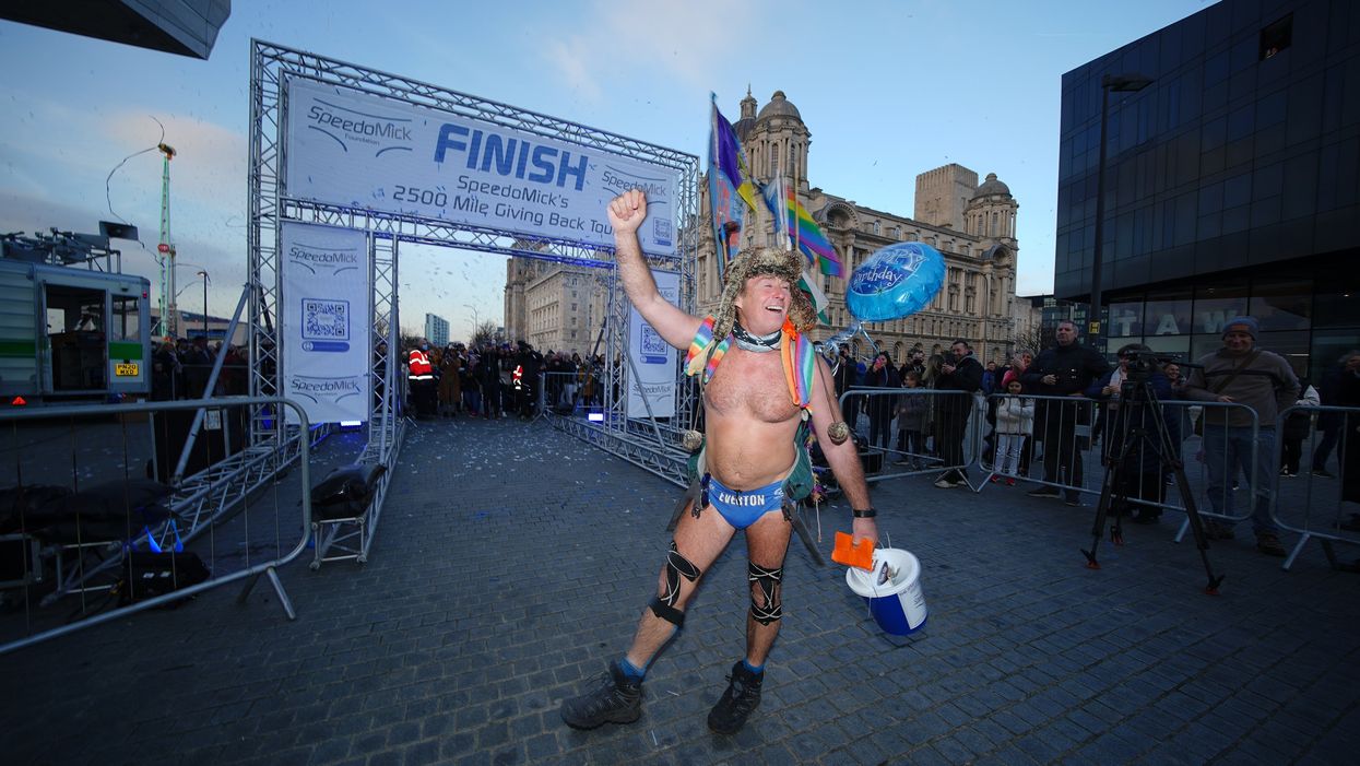 Mick Cullen, otherwise known as Speedo Mick, arrives in Liverpool, where he finished a 2,500-mile, five-month trek across the UK and Ireland (PA)