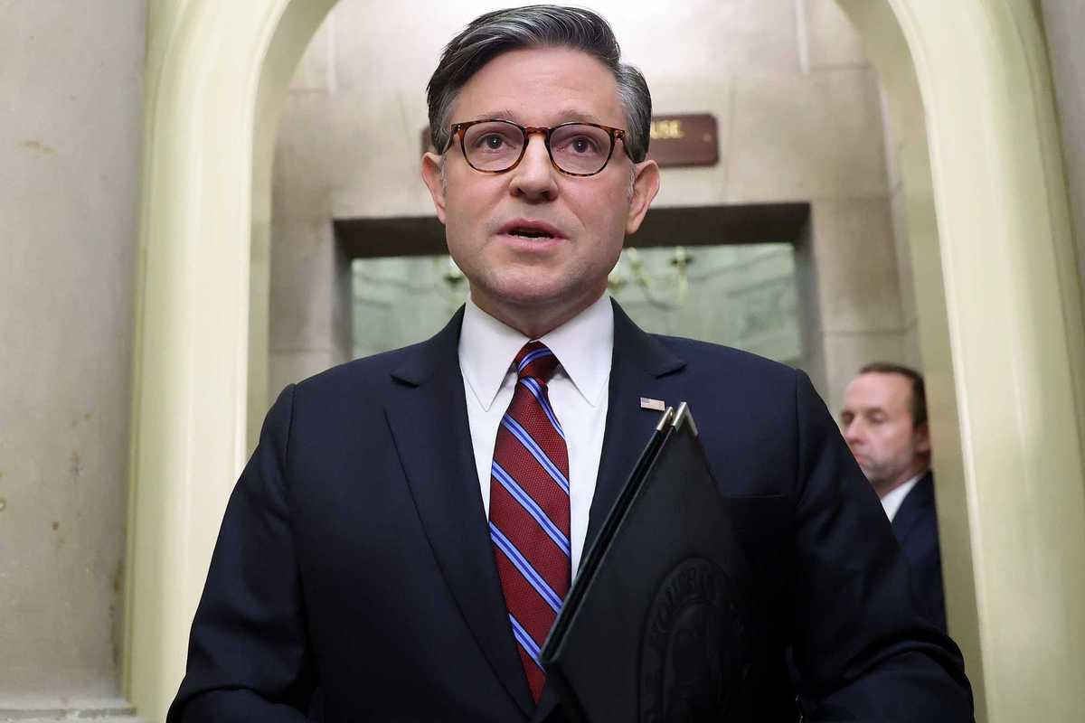 Mike Johnson, a white man with glasses, short grey hair and a dark blue suit.