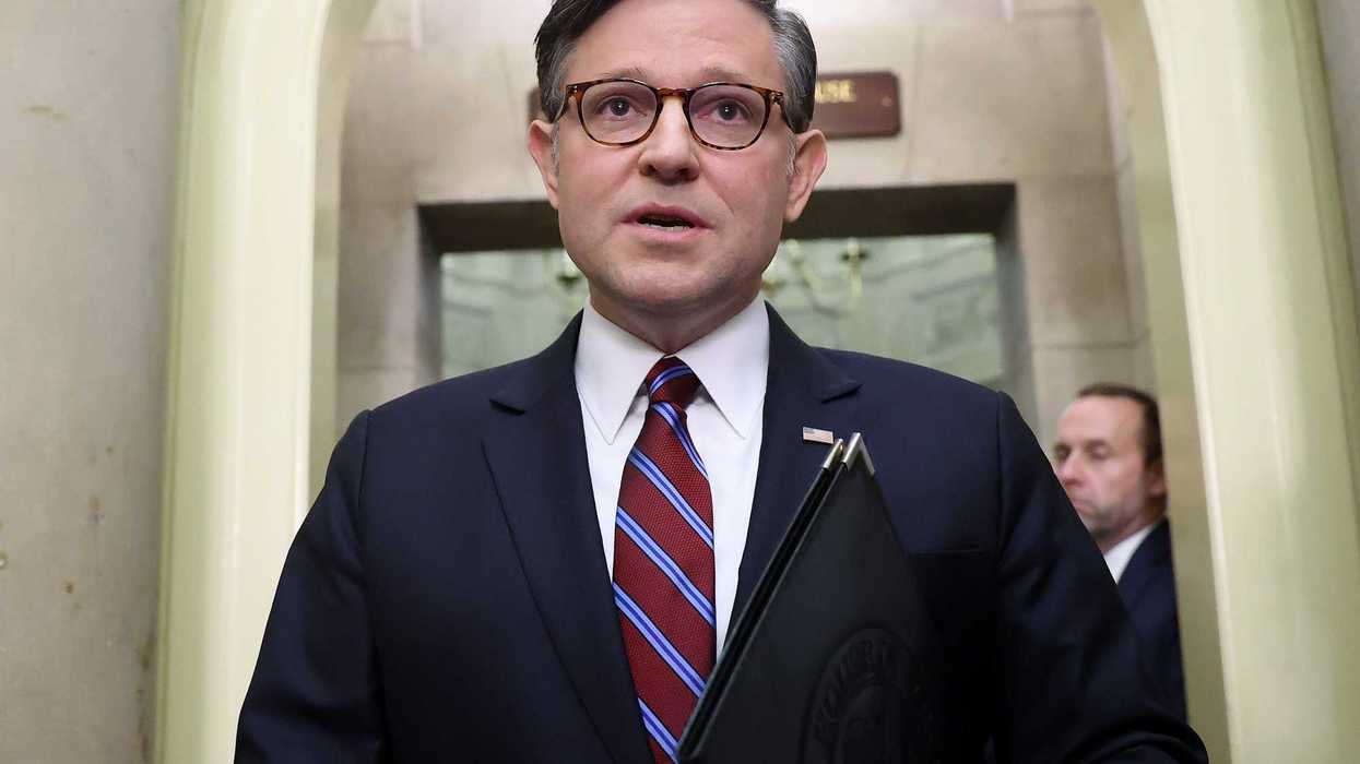 Mike Johnson, a white man with glasses, short grey hair and a dark blue suit.