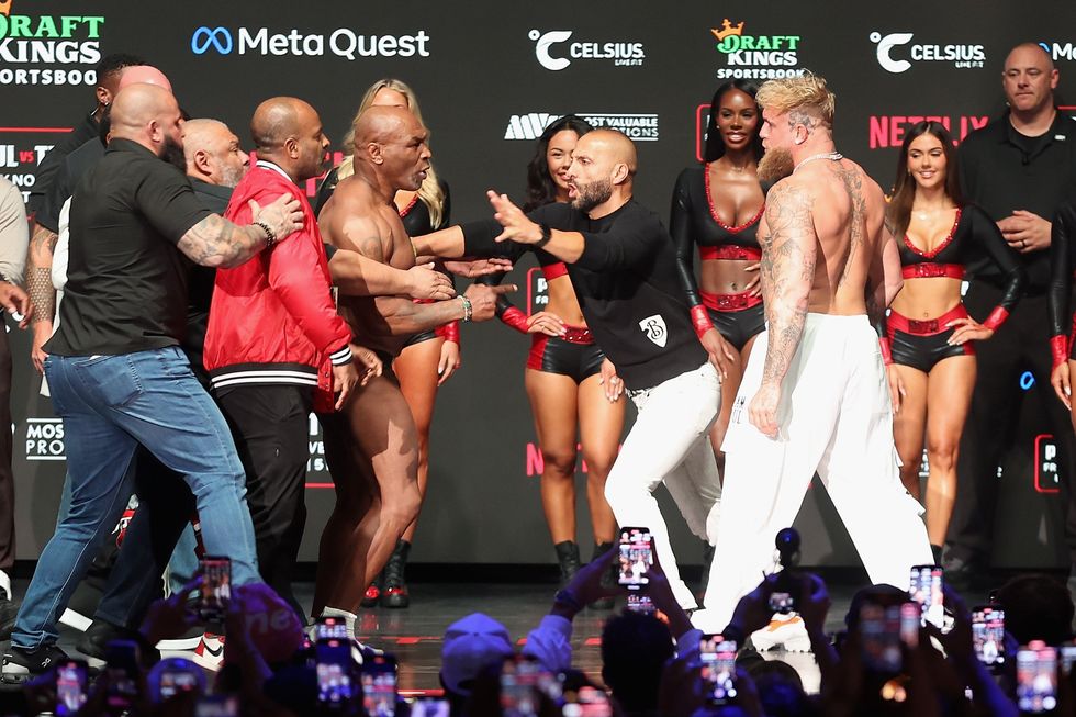 Mike Tyson and Jake Paul are separated as they face off during their ceremonial weigh-in at The Pavilion at Toyota Music Factory on November 14, 2024 in Irving, Texas