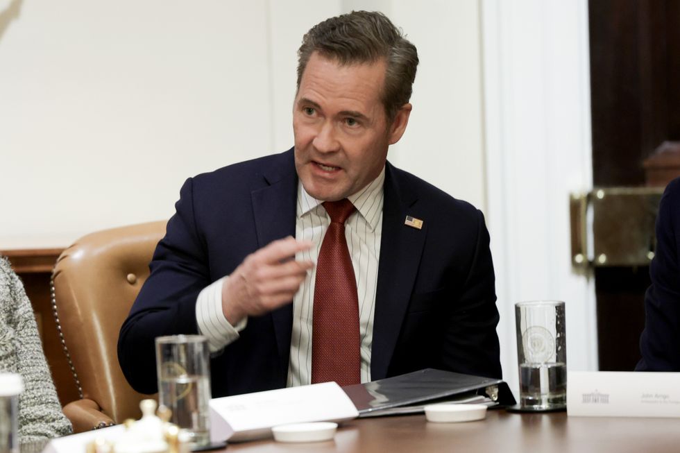 Mike Waltz speaks behind a wooden table at a cabinet meeting.