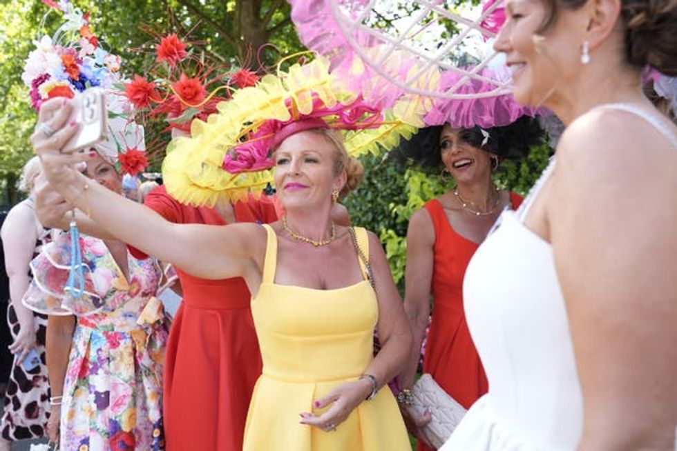 Milliner Viv Jenner, wearing her sustainable fashion hat, takes a selfie during Ladies' Day at Royal Ascot